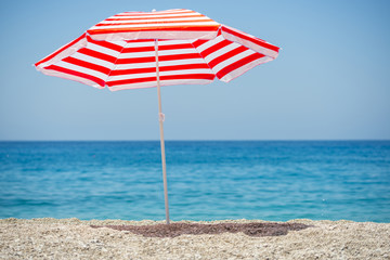Striped beach umbrella on the beach.

