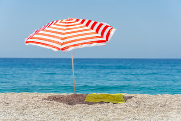 Striped beach umbrella on the beach.

