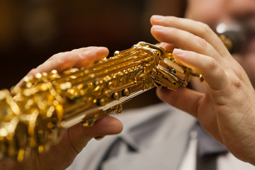 Hand of musician playing the soprano saxophone - obrazy, fototapety, plakaty
