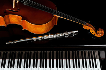 Fototapeta premium Musical instruments lying on the piano in dark colors