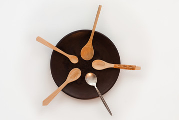 sharing concept - many wooden spoons and one silver spoon