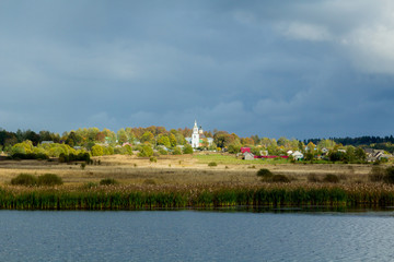 Fototapeta na wymiar Landscape with a lake and church and village.