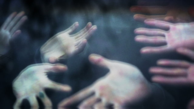 Horror scene. Zombie hands touch the car window