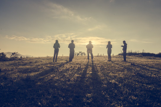 Group Of People standing with Sunrise Concept