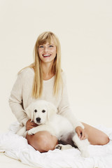 Young blond woman with puppy, portrait