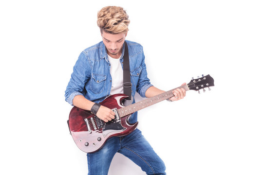 casual young man playing his electric guitar