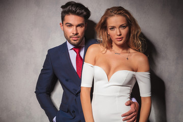 fashion elegant couple standing embraced in studio