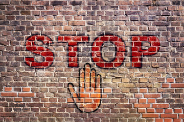Graffiti stop letters hand brick wall