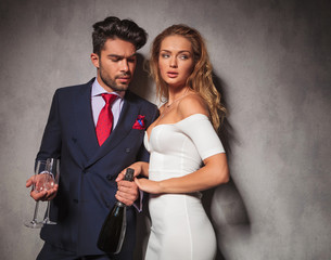 side view of an elegant couple with champagne and glasses