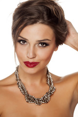 a young beautiful woman posing with a big necklace