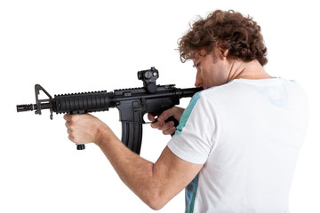 Rear side view of curly hair adult man aiming with black machinegun, isolated on white background