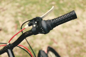 Close up of a red and black mountain bicycle handle.