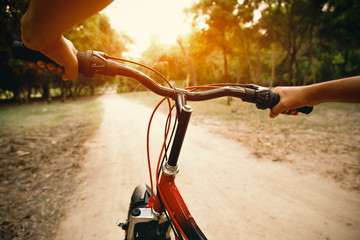 Fototapeta na wymiar hands of a man on mountain bicycle handlebars in morning