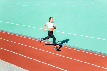 Fototapeta premium Female jogger running at stadium