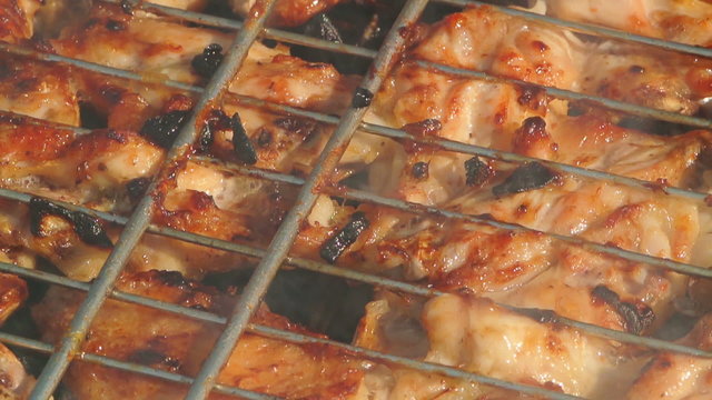 Close-up shot of chicken wings on barbeque outdoors on a sunny sunday afternoon