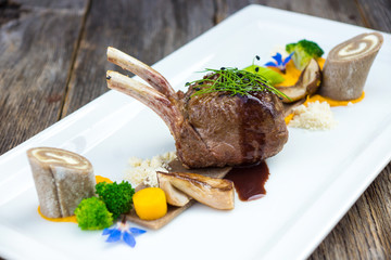 Delicious chops deer with dumplings and vegetables