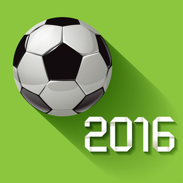 Soccer ball 2016 with long shadow on a green background.