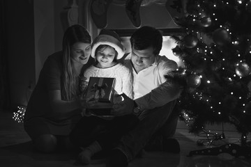 happy family looking inside of Christmas gift box