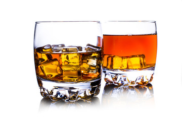 Glass of whiskey with ice isolated on white