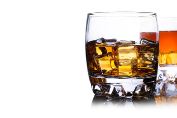 Glass of whiskey with ice isolated on white