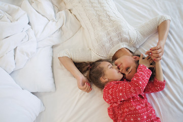 Mom with daughter in the bed
