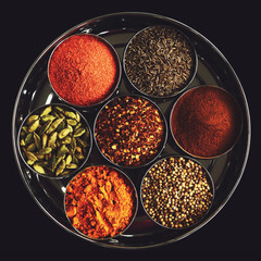 Rack with traditional indian spices for cooking - cardamom, turmeric, cumin, coriander seeds, cinnamon and chili - 93901977