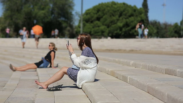 Teenage girl takeing photo at the amphitheater of Belem in