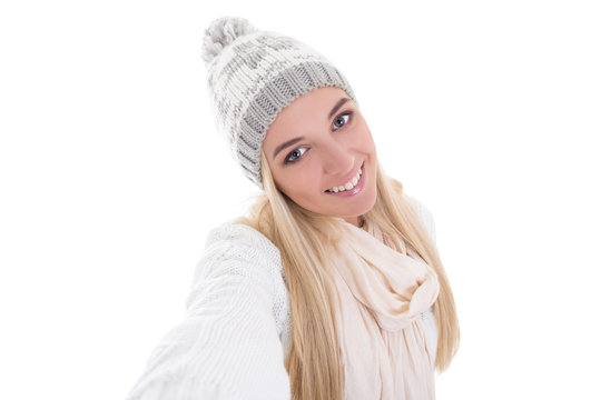 beautiful blond woman in winter clothes taking selfie photo isol
