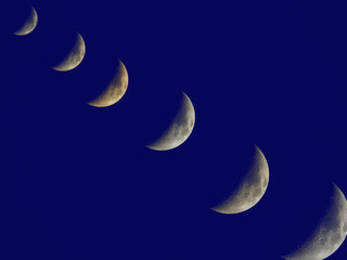 Obraz na płótnie Canvas crescent moon setting in the blue sky