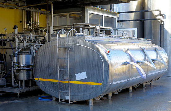 Large stainless steel tank containing milk located in a dairy food-processing industry