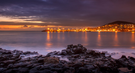 Beautiful lava seashore near the city of Arona in Tenerife during sunset.