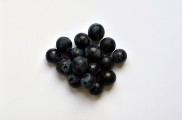 Heap of blue vine berries on white background