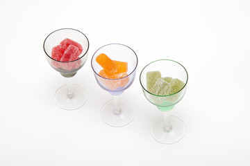 colors marmalade in wineglass on white  backgrounds