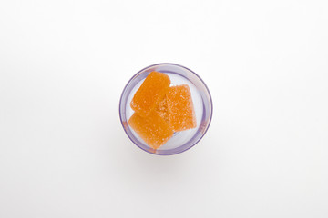 orange marmalade in black wineglass on white