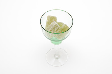 green marmalade in green wineglass on white