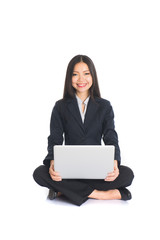 asian chinese female sitting and using laptop