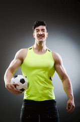 Muscular man with football ball © Elnur