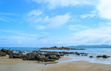 Fototapeta na wymiar The rocks on the beach and blue sky background