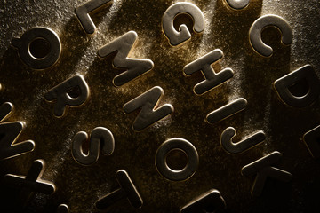 English alphabet on a gold background