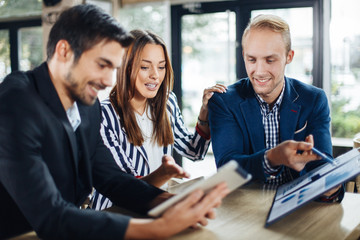 Small group of young people at a business meeting in a cafe