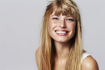 Lovely young woman smiling in studio