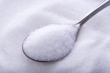 Spoonfuls of crystal white sugar