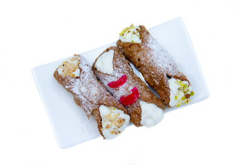 Cannoli with ricotta cheese on a white background seen from above