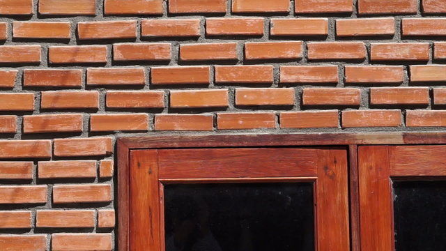 Video of red brick wall texture with wooden frame window