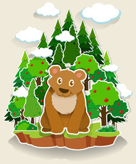 Brown bear sitting in the forest