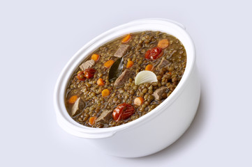 Pot of lentils with meat and white background