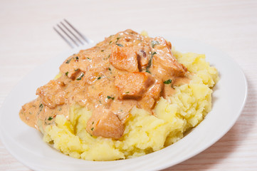 chicken breast in a creamy sauce with mashed potatoes
