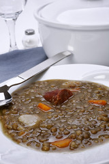 Closeup of a dish of lentils with carrots, chorizo and potatoes