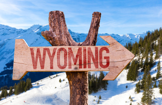 Wyoming Wooden Sign With Winter Background