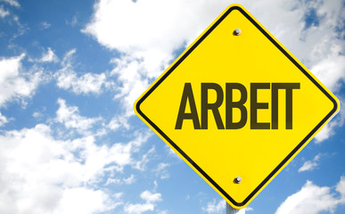 Work (in German) sign with sky background